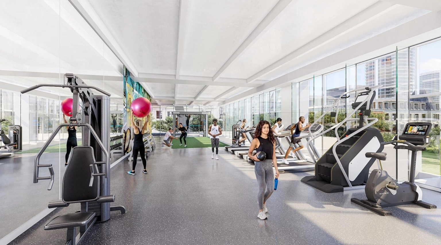 Fitness center interior at 23Springs featuring cardio and strength equipment, natural daylight, and views of the surrounding Dallas skyline.