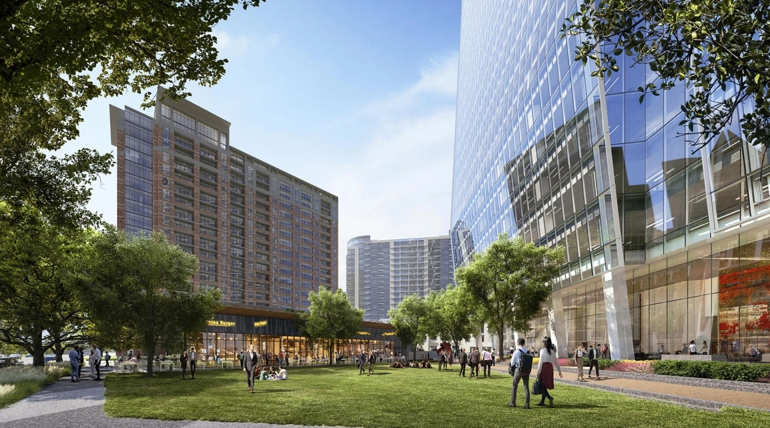 View of 23Springs public green space with people walking, sitting, and dining near the tower and retail pavilion.