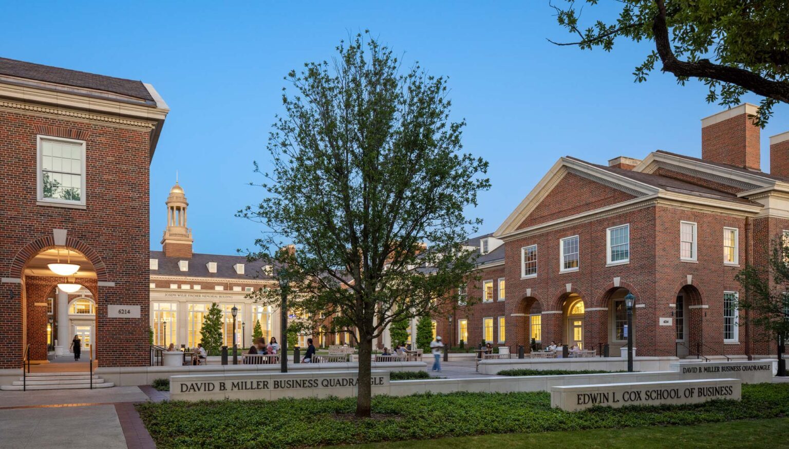 View across the David B. Miller Business Quadrangle showing interconnected Georgian buildings of the SMU Cox School of Business with pedestrian circulation and seating.