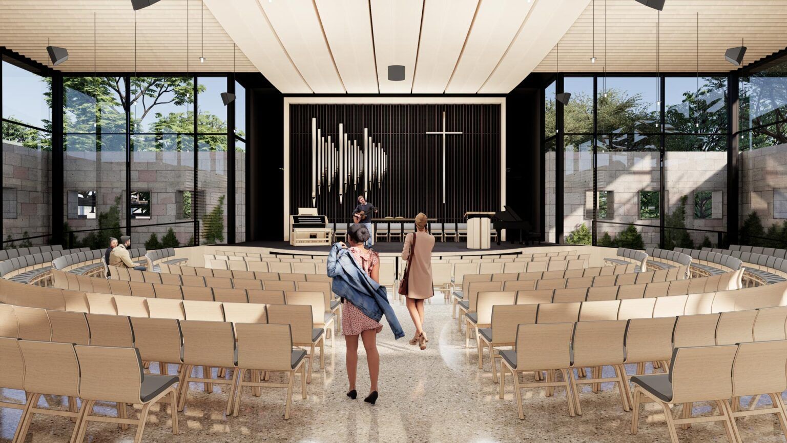 Interior view of Concordia Chapel with curved seating, pipe organ, and glass walls revealing preserved garden stone walls and trees.