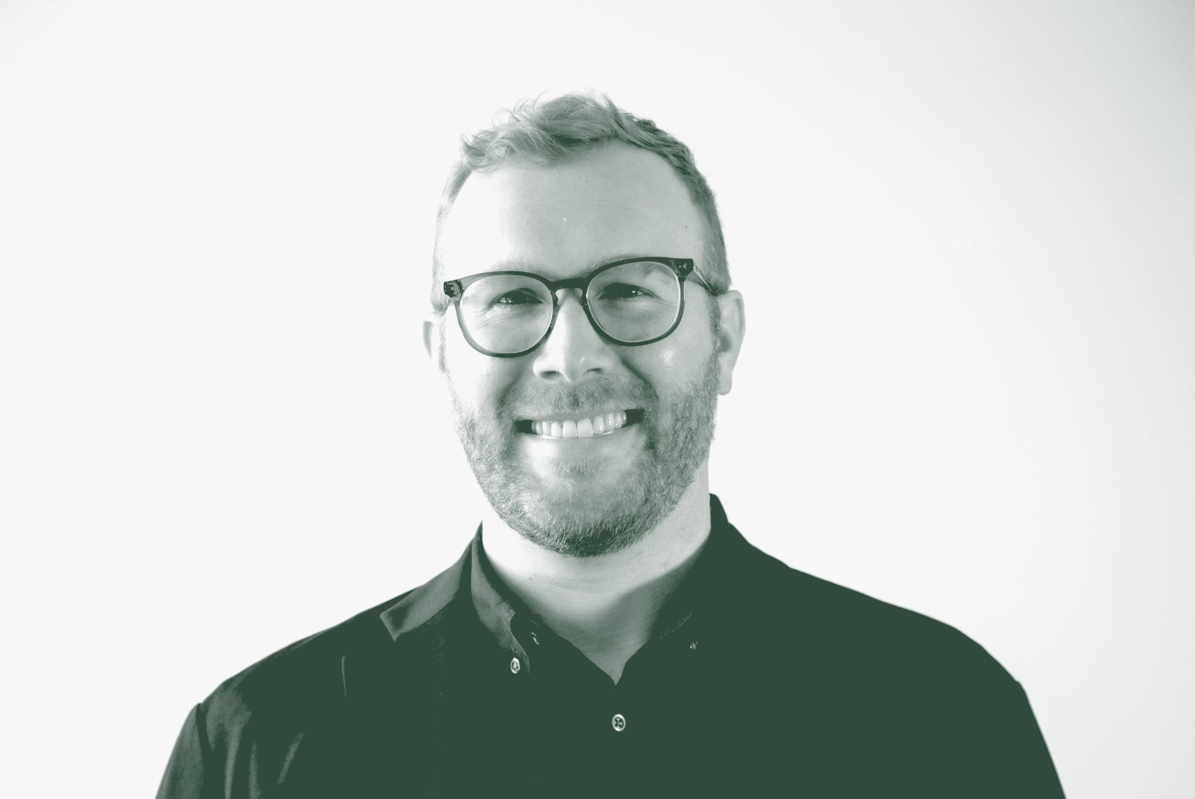 Blake Thames Portrait A black and white portrait of Blake Thames, an Associate and Senior Design Leader with GFF, in front of a white background.