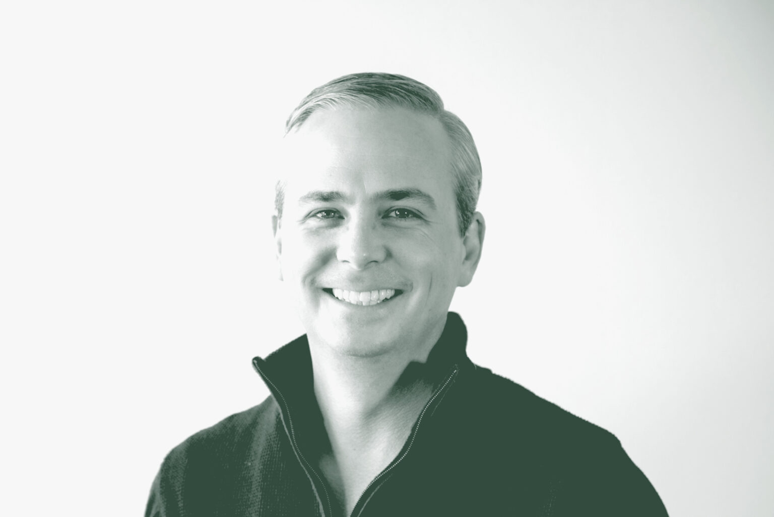 A black and white portrait of Evan Beattie, a Principal and the Chief Executive Officer / Chairman with GFF, in front of a white background.