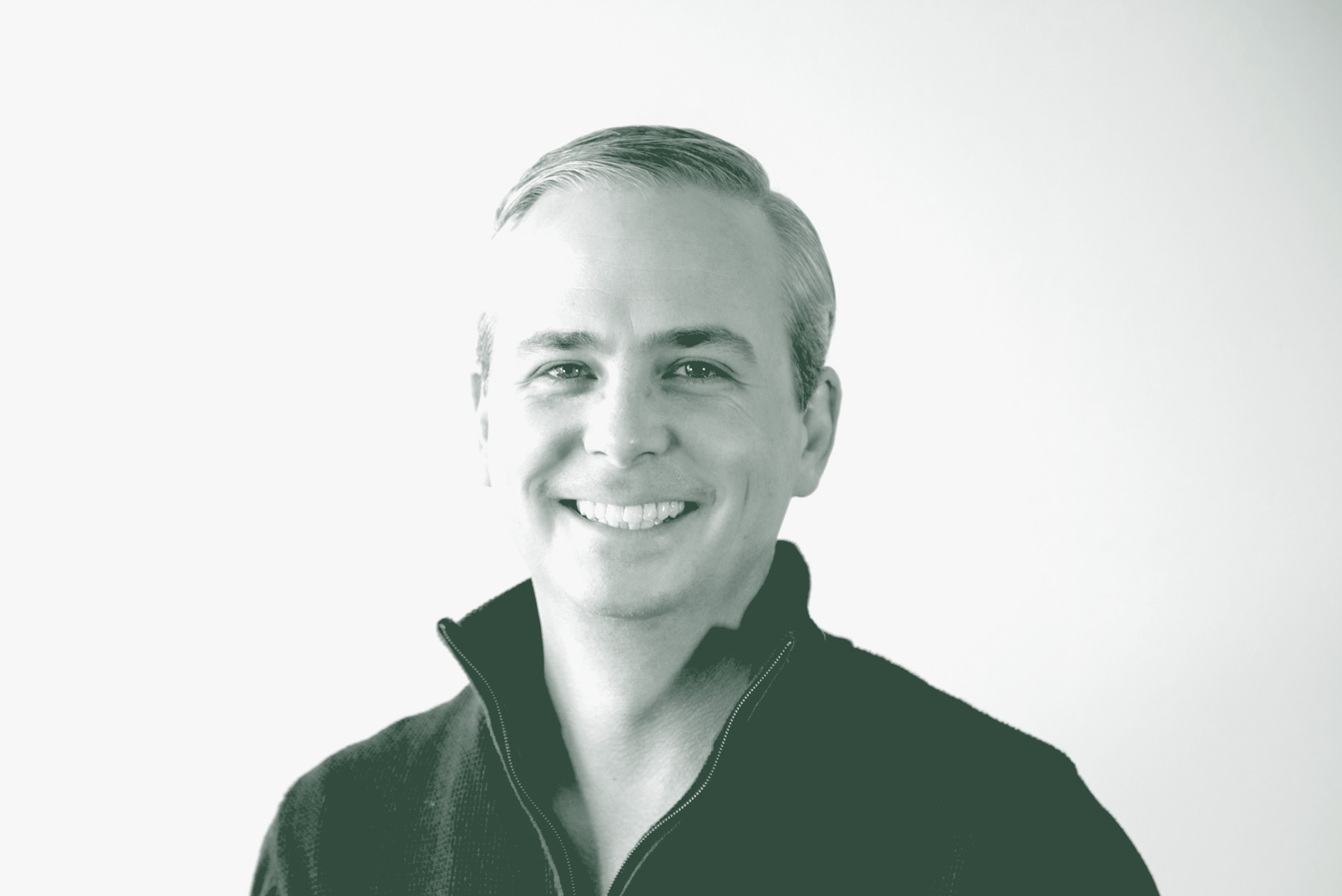 A black and white portrait of Evan Beattie, a Principal and the Chief Executive Officer / Chairman with GFF, in front of a white background.