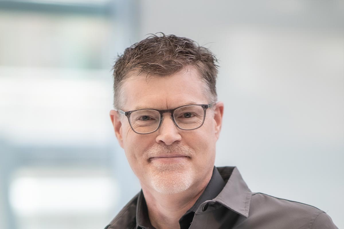 Brian Moore, Principal and Director of Planning at GFF, close-up portrait with glasses and soft background light in the office.