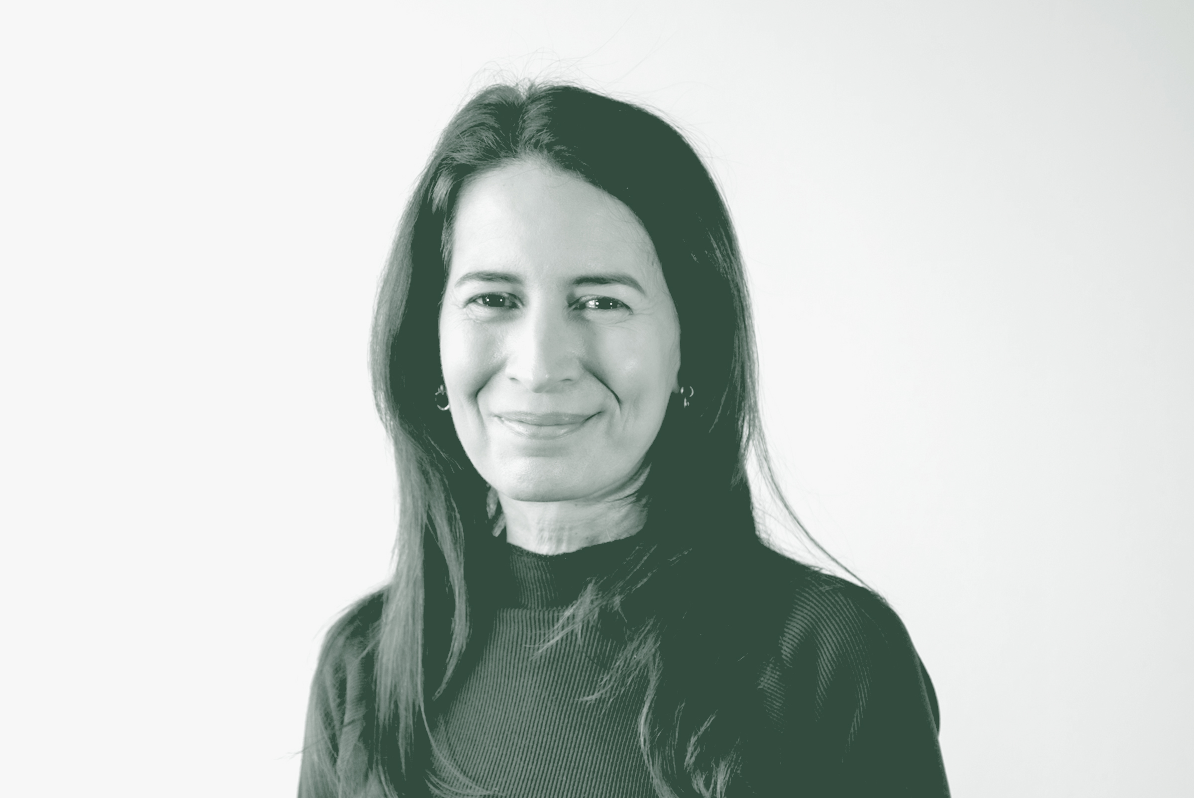 A black and white portrait of Maria Gomez, a Principal and Studio Director with GFF in the Corporate / Office Studio, in front of a white background.