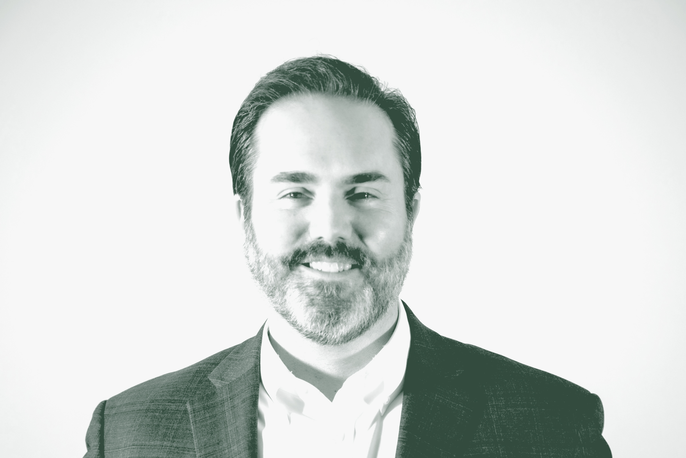 A black and white portrait of Todd Burtis, a Design Principal with GFF, in front of a white background.