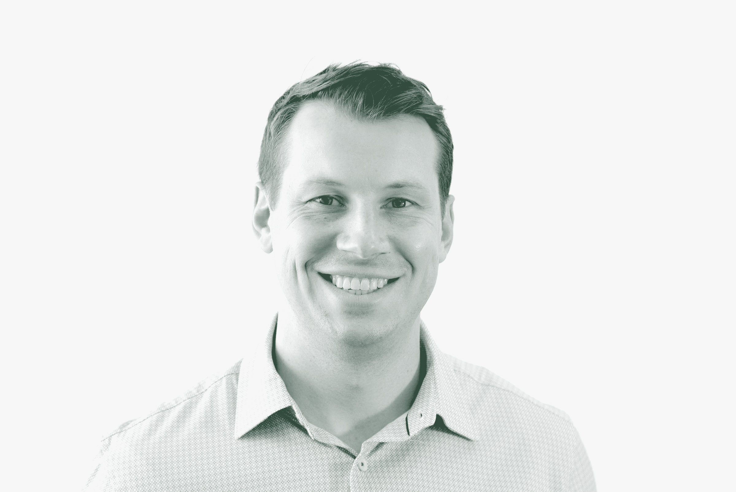 A black and white portrait of Garrett Barker, an Associate and Senior Project Leader with GFF in the Civic Studio, in front of a white background.