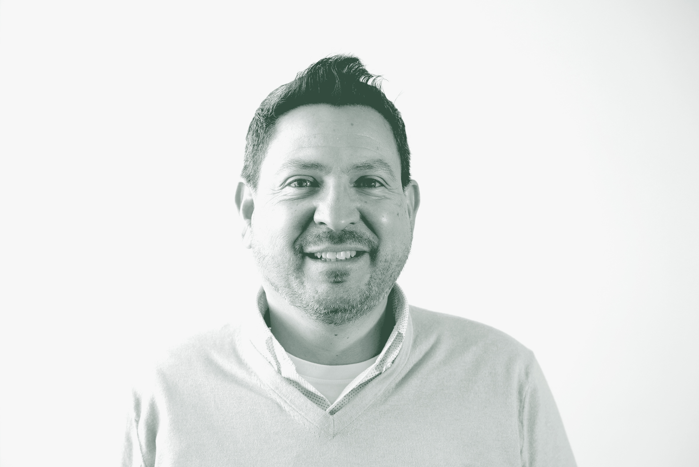 A black and white portrait of Eric Marquez de la Plata, a Senior Project Leader with GFF in the Retail Studio, in front of a white background.