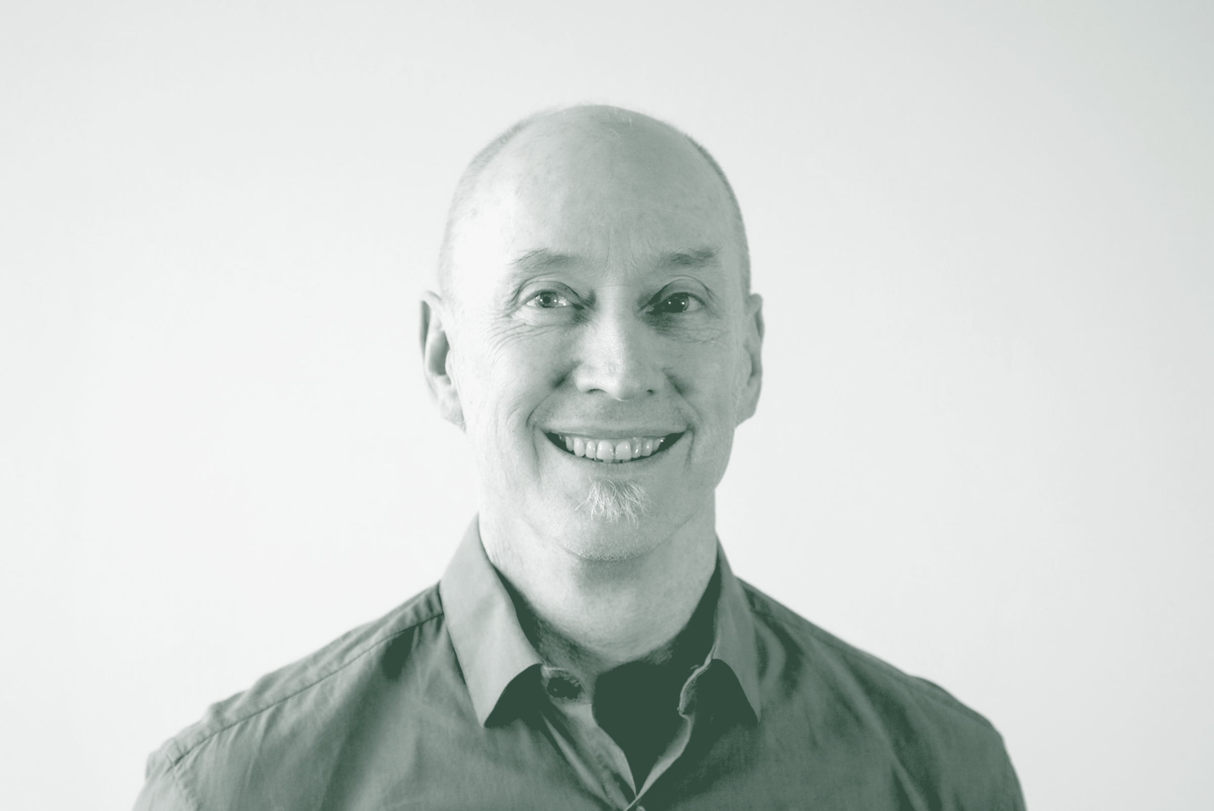 A black and white portrait of Brad Smith, a Senior Landscape Architecture Leader with GFF in the Landscape Architecture Studio, in front of a white background.