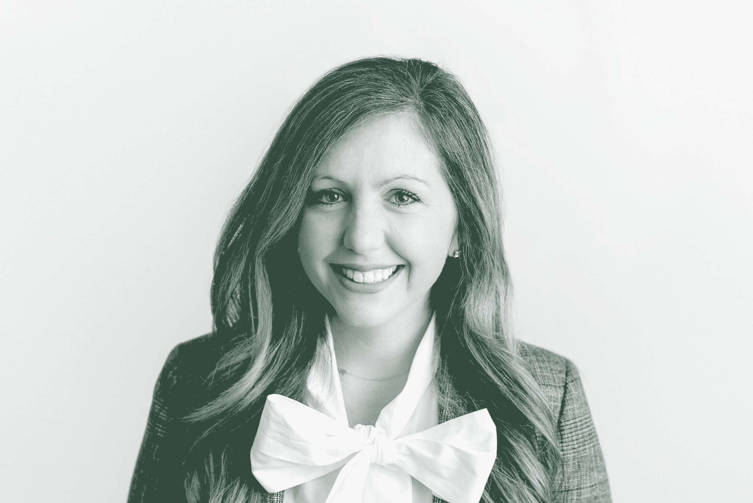 A black and white portrait of Reagan Compton, an Interior Design Leader with GFF in the Interior Design Studio, in front of a white background.