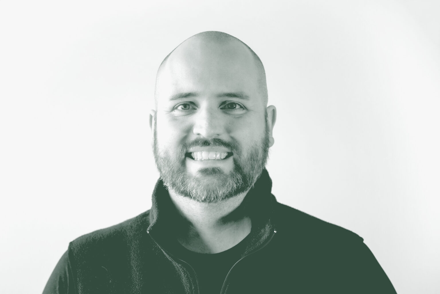 A black and white portrait of Jason Hoyt, an Associate and Studio Director with GFF in the Mixed-Use & Multifamily Studio, in front of a white background.