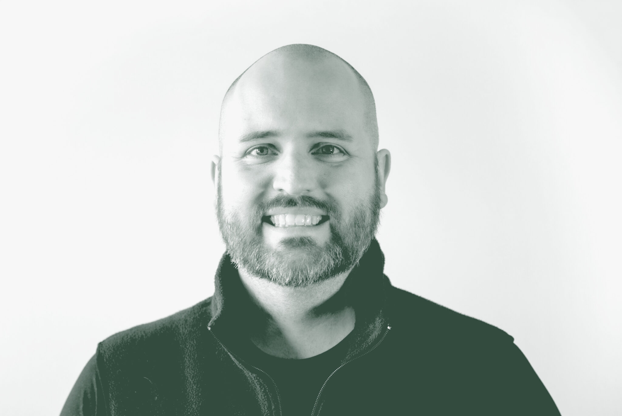 A black and white portrait of Jason Hoyt, an Associate and Studio Director with GFF in the Mixed-Use & Multifamily Studio, in front of a white background.