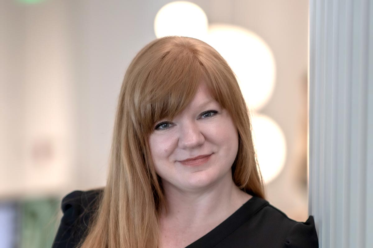 Emily Mendez, GFF Associate and Director of Sustainability, professional headshot with blurred office background.