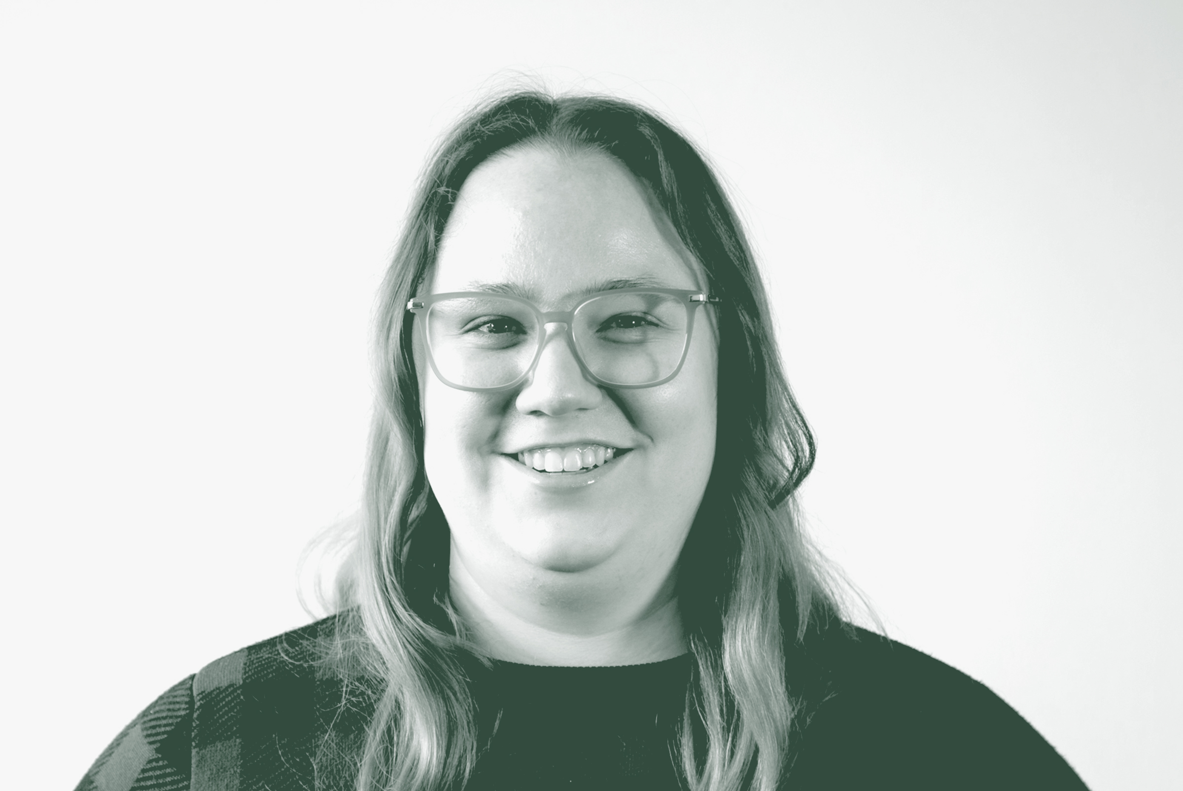 A black and white portrait of Alexis Kaleri, a Senior Project Coordinator with GFF in the Mixed-Use & Multifamily Studio, in front of a white background.