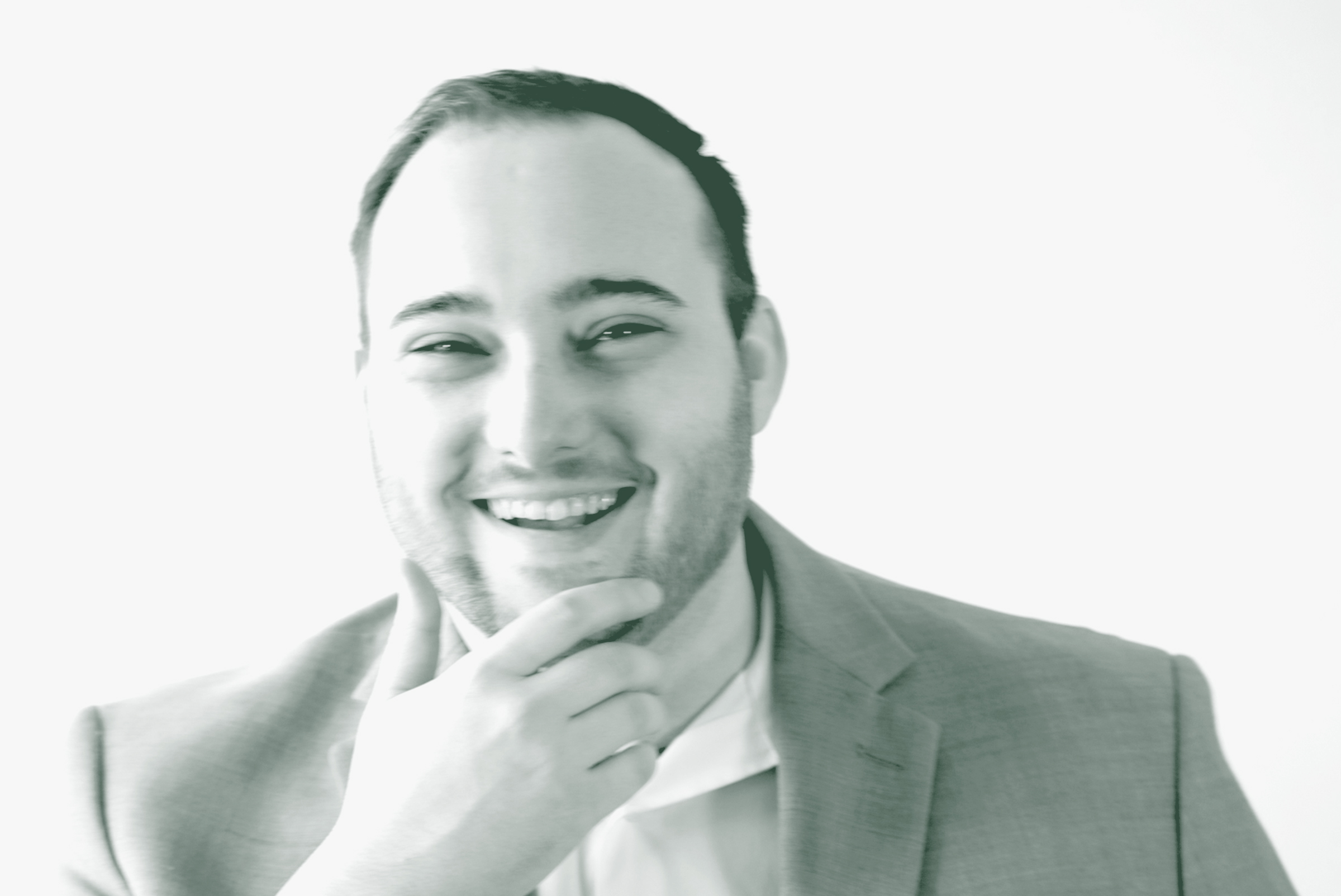 A black and white portrait of Drake Johnson, a Landscape Architecture Leader with GFF in the Landscape Architecture Studio, in front of a white background.