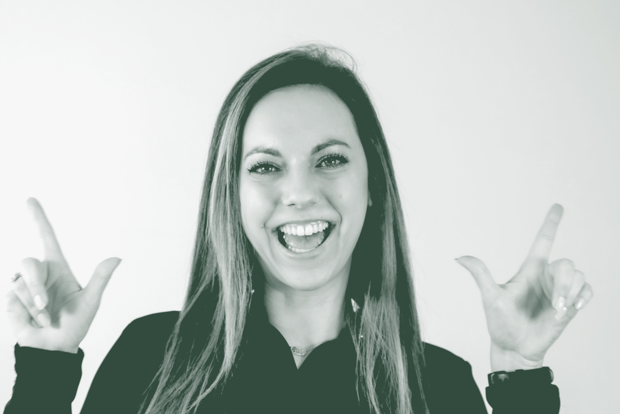 A black and white portrait of Marissa Clinesmith, a Project Coordinator with GFF in the Fort Worth Studio, in front of a white background.