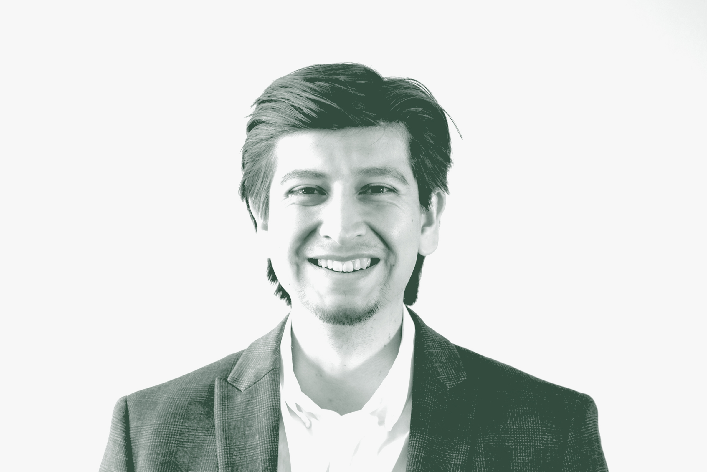A black and white portrait of Roberto Oviedo, a Senior Project Coordinator with GFF in the Corporate / Office Studio, in front of a white background.