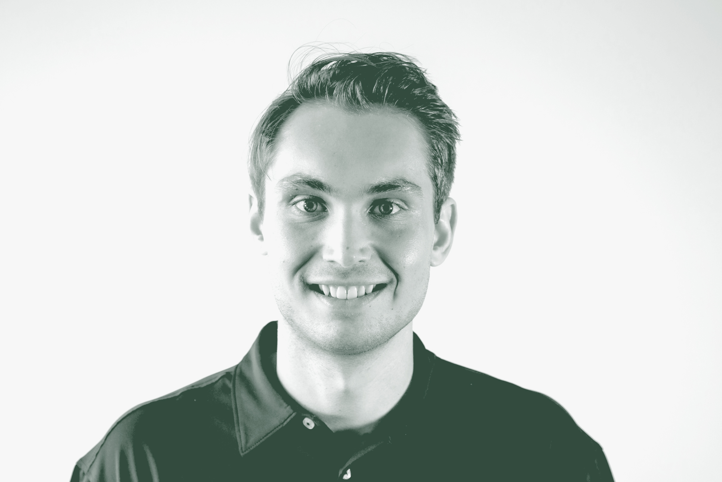 A black and white portrait of Carson Guy, a Project Coordinator with GFF in the Corporate / Office Studio, in front of a white background.