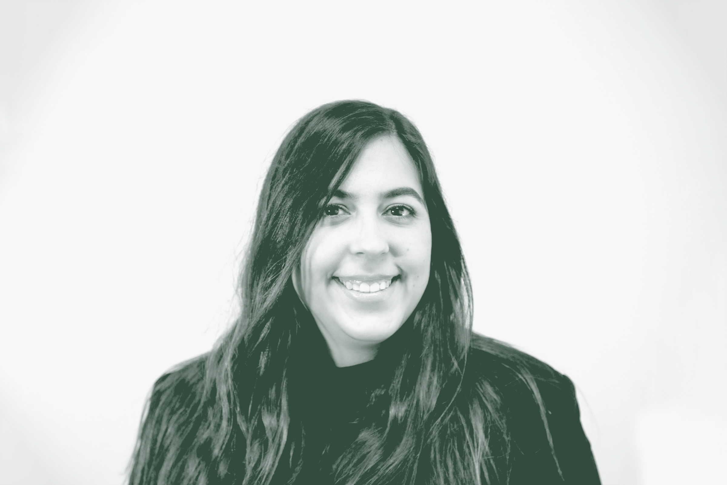 A black and white portrait of Alejandra Rodriguez, an Architectural Professional with GFF in the Austin Studio, in front of a white background.