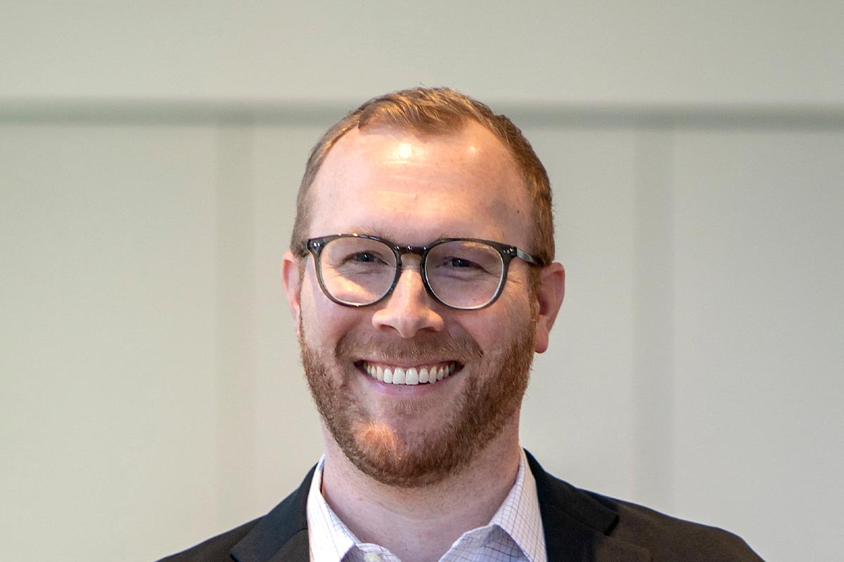 Blake Thames, Associate and Senior Design Leader at GFF, close-up portrait with neutral background and warm natural light.