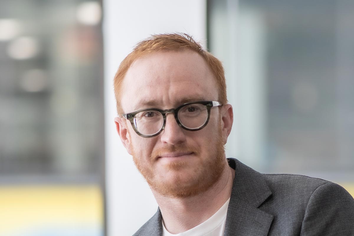 Christopher Day, Associate and Senior Design Leader at GFF, close-up portrait with soft daylight and architectural background.