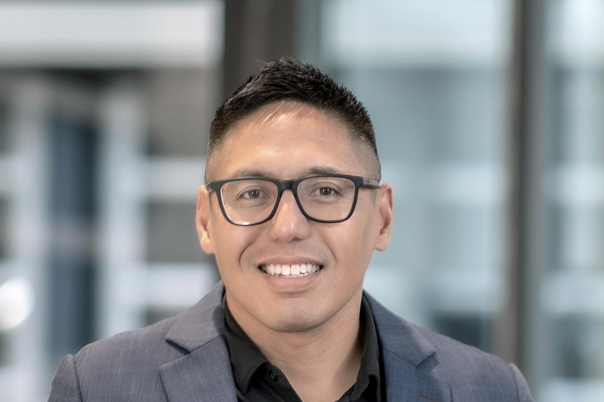 Lance Abaya, Associate and Senior Design Leader at GFF, close-up portrait in natural light with soft architectural background.
