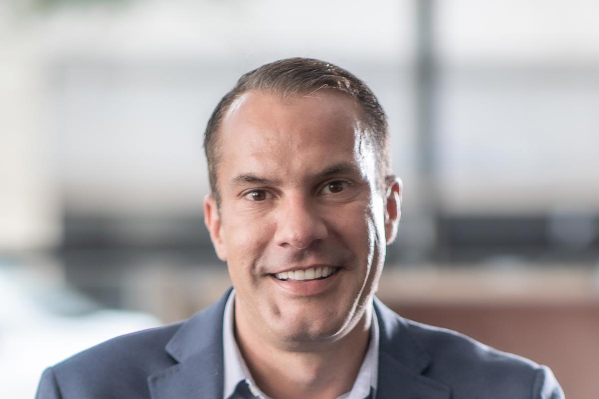 A cropped landscape portrait of Bart Wilburn, Senior HR Leader at GFF, smiling in a bright professional setting.