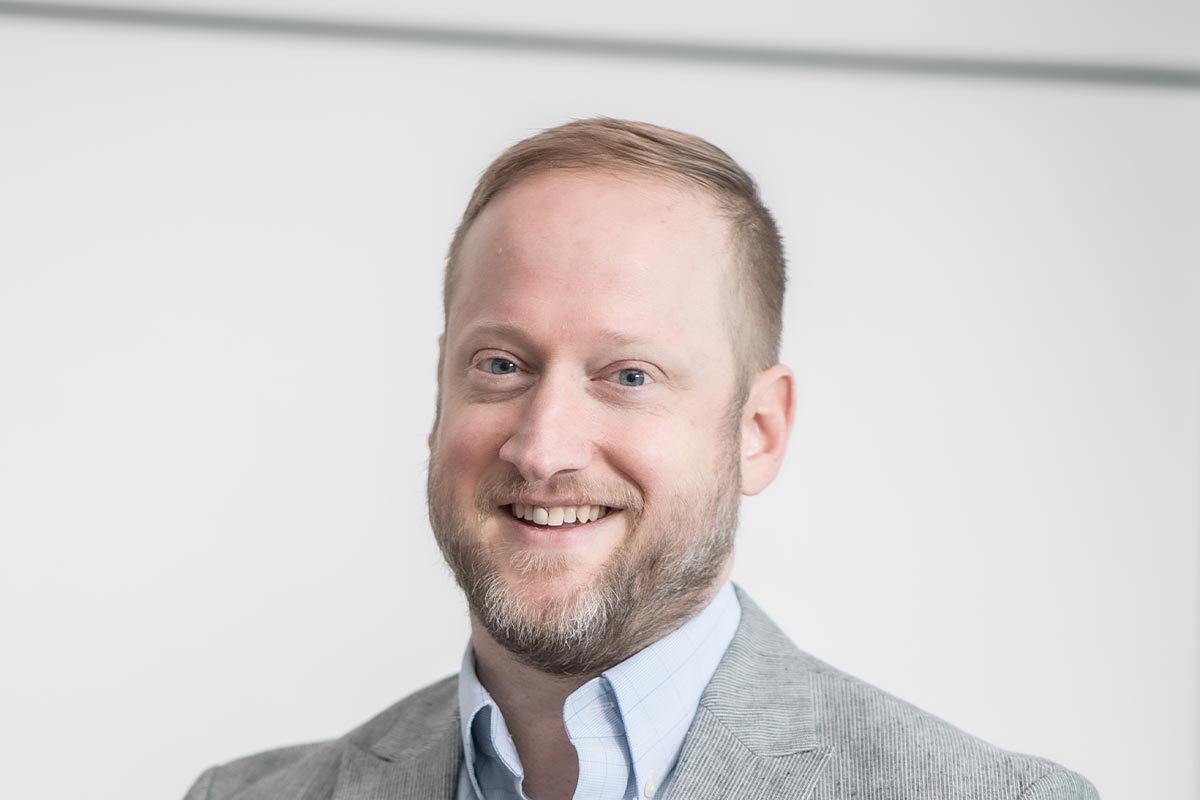 A cropped landscape portrait of David Anderson, Senior Project Leader at GFF, smiling in a bright neutral-toned setting.