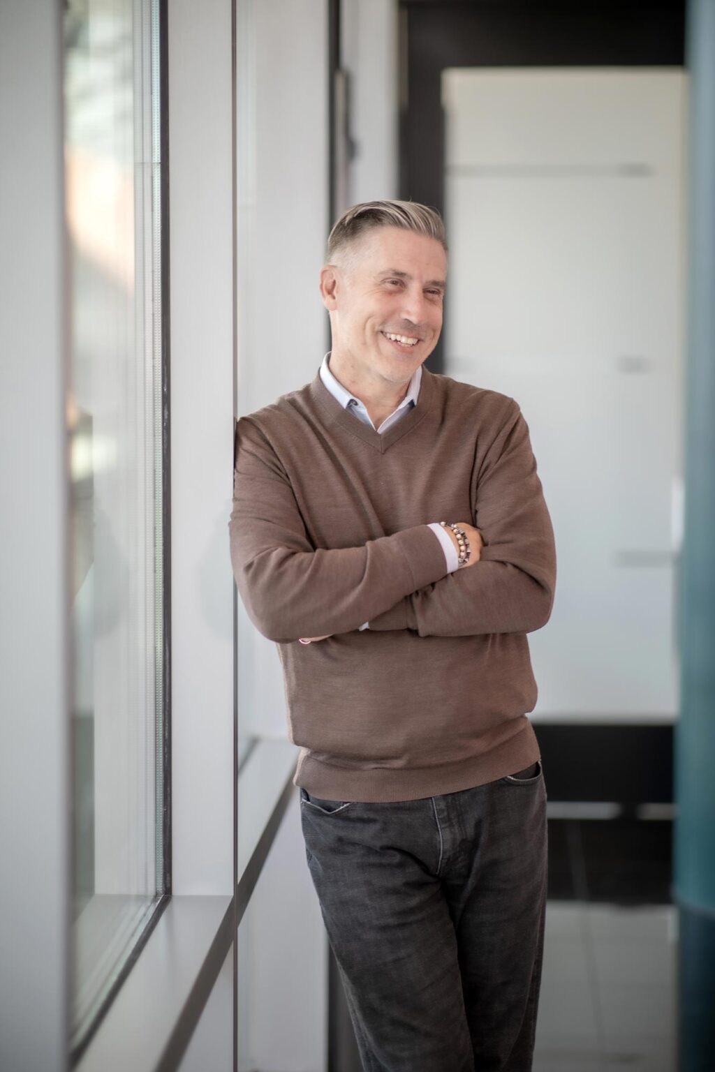 Michael Geist, AIA NCARB Senior Project Leader at GFF, photographed in a bright Dallas office interior, leading educational, civic, and commercial architecture projects.