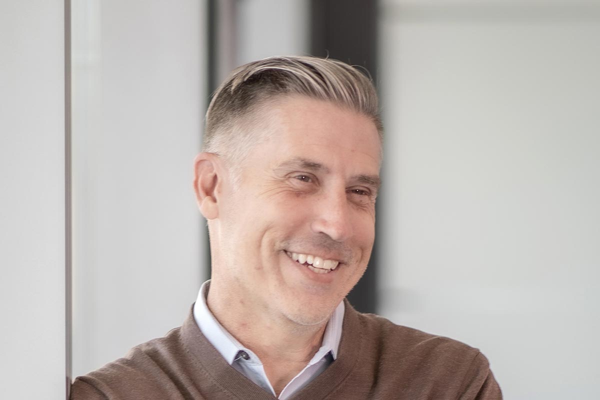 Michael Geist, AIA NCARB Senior Project Leader at GFF Dallas, close-up professional portrait in a modern design firm setting.