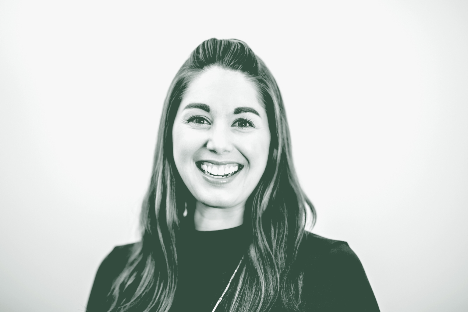 A black and white portrait of Katie Myers Wender, a Senior Interior Design Coordinator with GFF in the Interior Design Studio, in front of a white background.