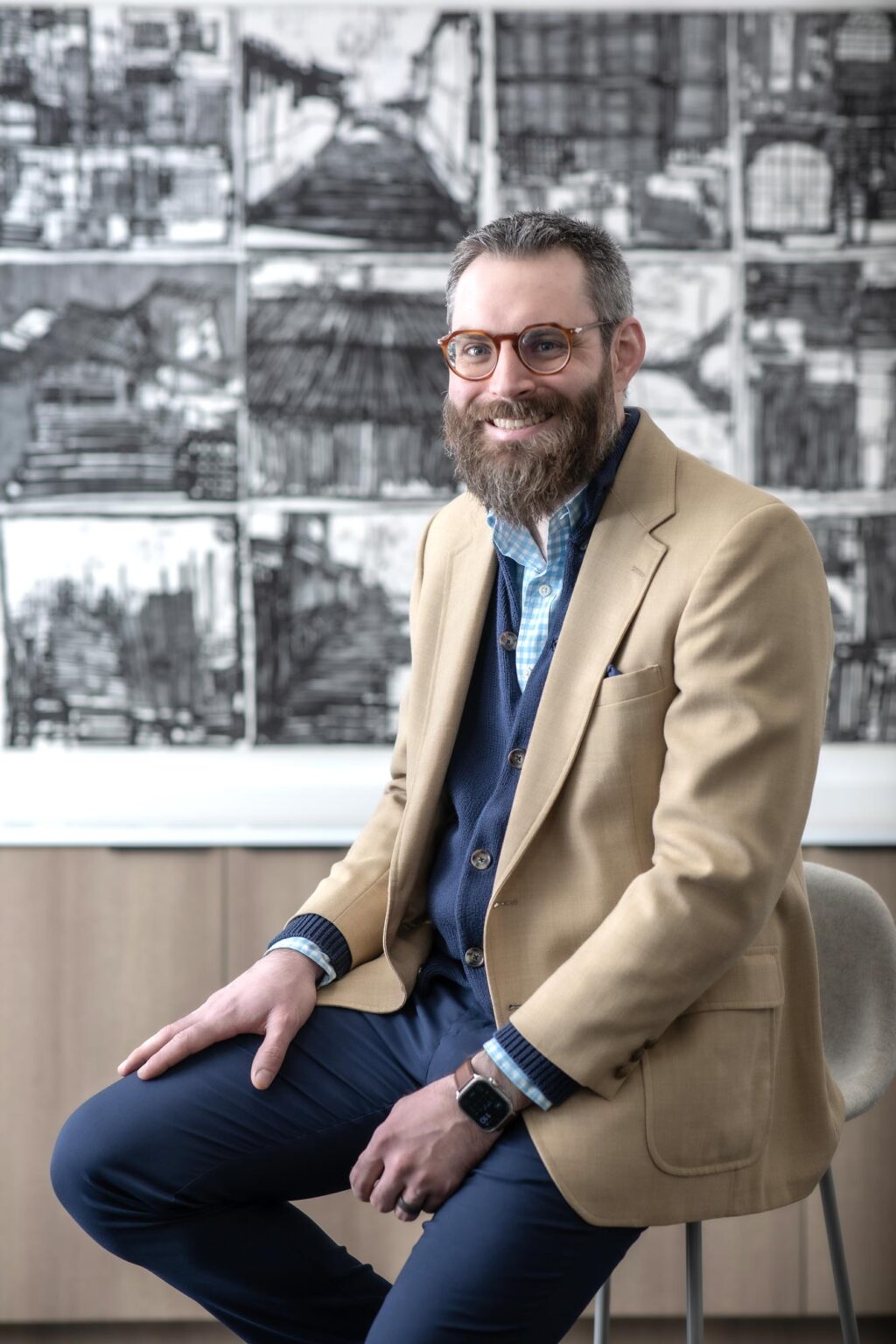 John Laurence, Senior Project Coordinator in GFF’s Retail & Hospitality studio, photographed in a Dallas office interior with contemporary architectural artwork.