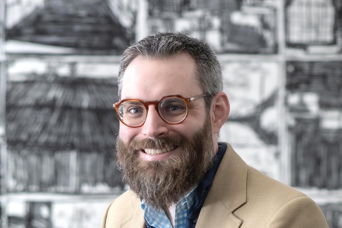 John Laurence, Senior Project Coordinator at GFF Dallas, close-up professional portrait in a modern design firm workplace.
