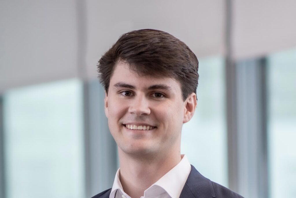 Coleman Brink, Design Coordinator at GFF, close-up professional portrait with soft window light and blurred office interior.