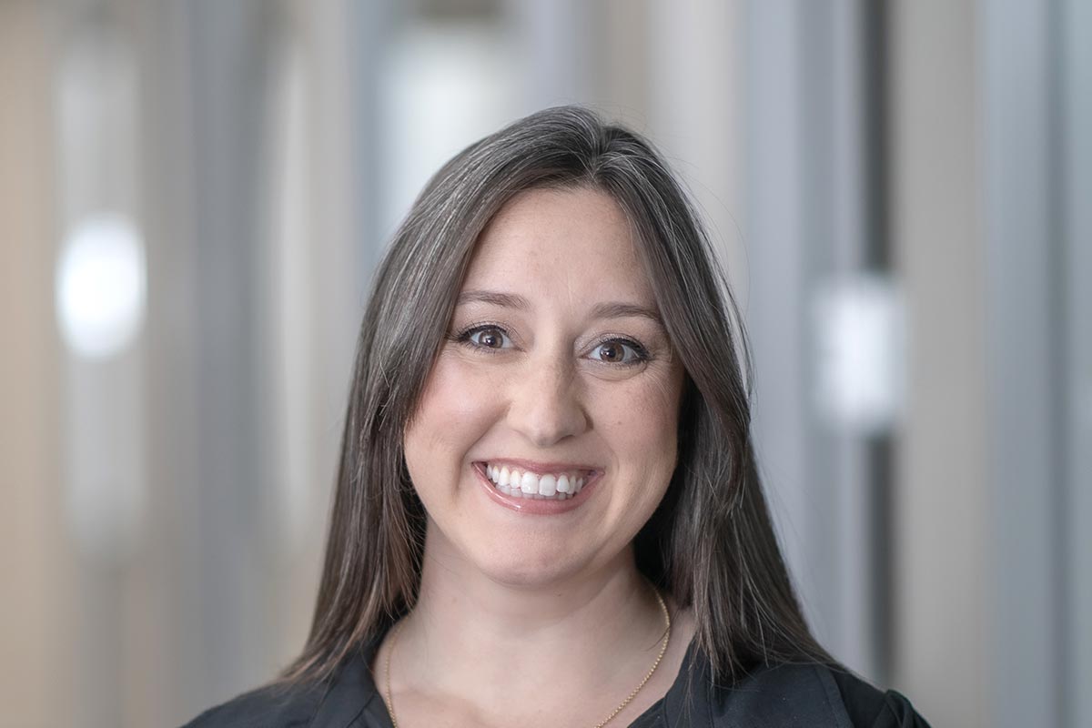 A cropped landscape portrait of Maureen Hellerstedt, Marketing Coordinator at GFF, smiling in front of a softly lit office background.