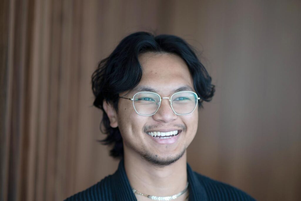 Vince Hernandez, Architectural Professional at GFF Austin, close-up professional portrait in a contemporary design firm setting.