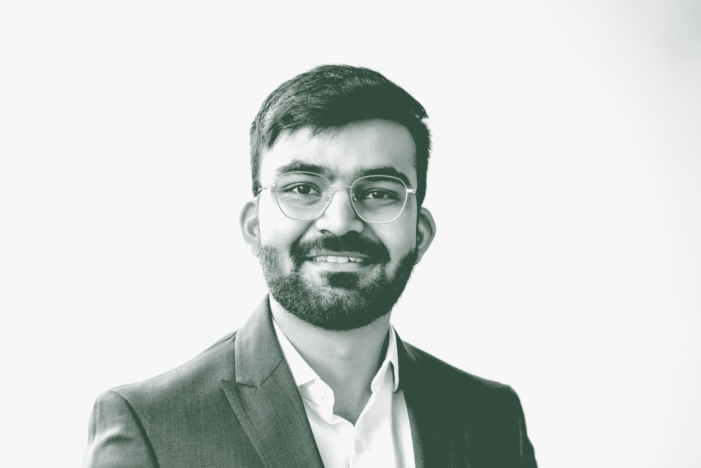 A black and white portrait of Nikunj Vara, an Architectural Professional with GFF in the Retail & Hospitality Studio, in front of a white background.