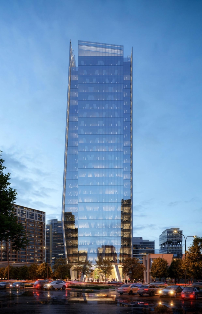 Street View Frontal elevation of the 23Springs office tower at dusk, with reflective glass facade and illuminated lobby.