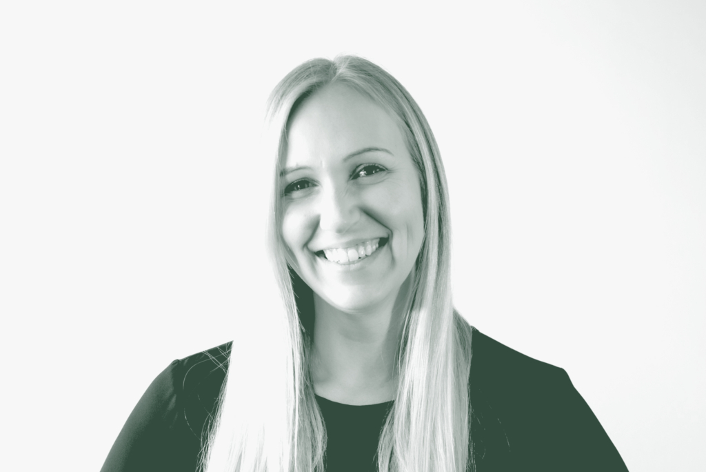 A black and white portrait of Alix Rios, an Associate Principal and Studio Director with GFF in the Interior Design Studio, in front of a white background.