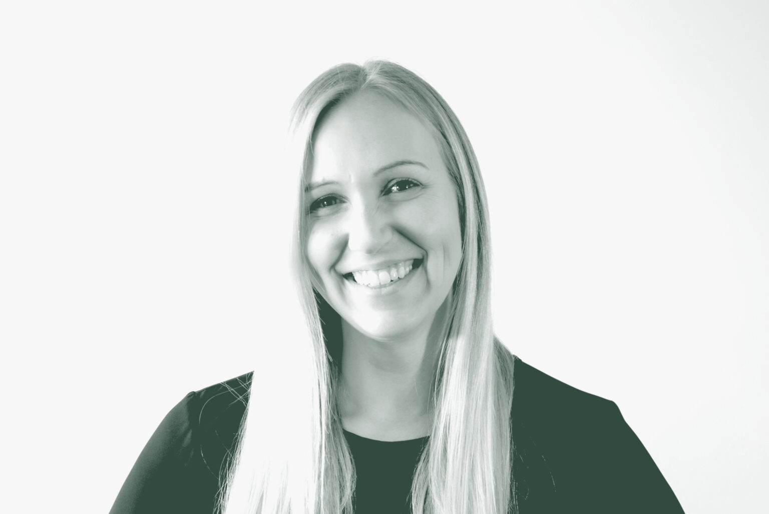 A black and white portrait of Alix Rios, an Associate Principal and Studio Director with GFF in the Interior Design Studio, in front of a white background.