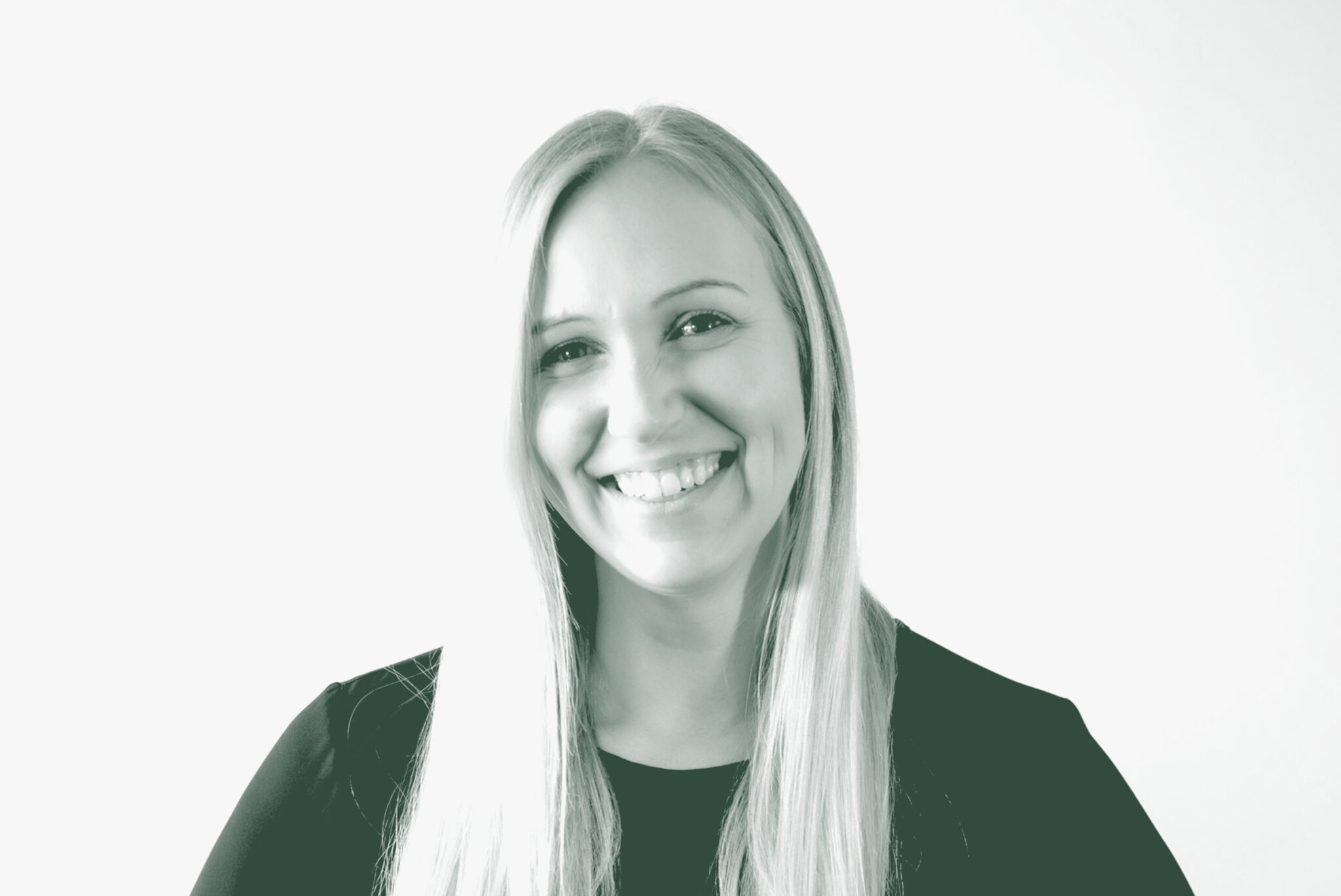 A black and white portrait of Alix Rios, an Associate Principal and Studio Director with GFF in the Interior Design Studio, in front of a white background.