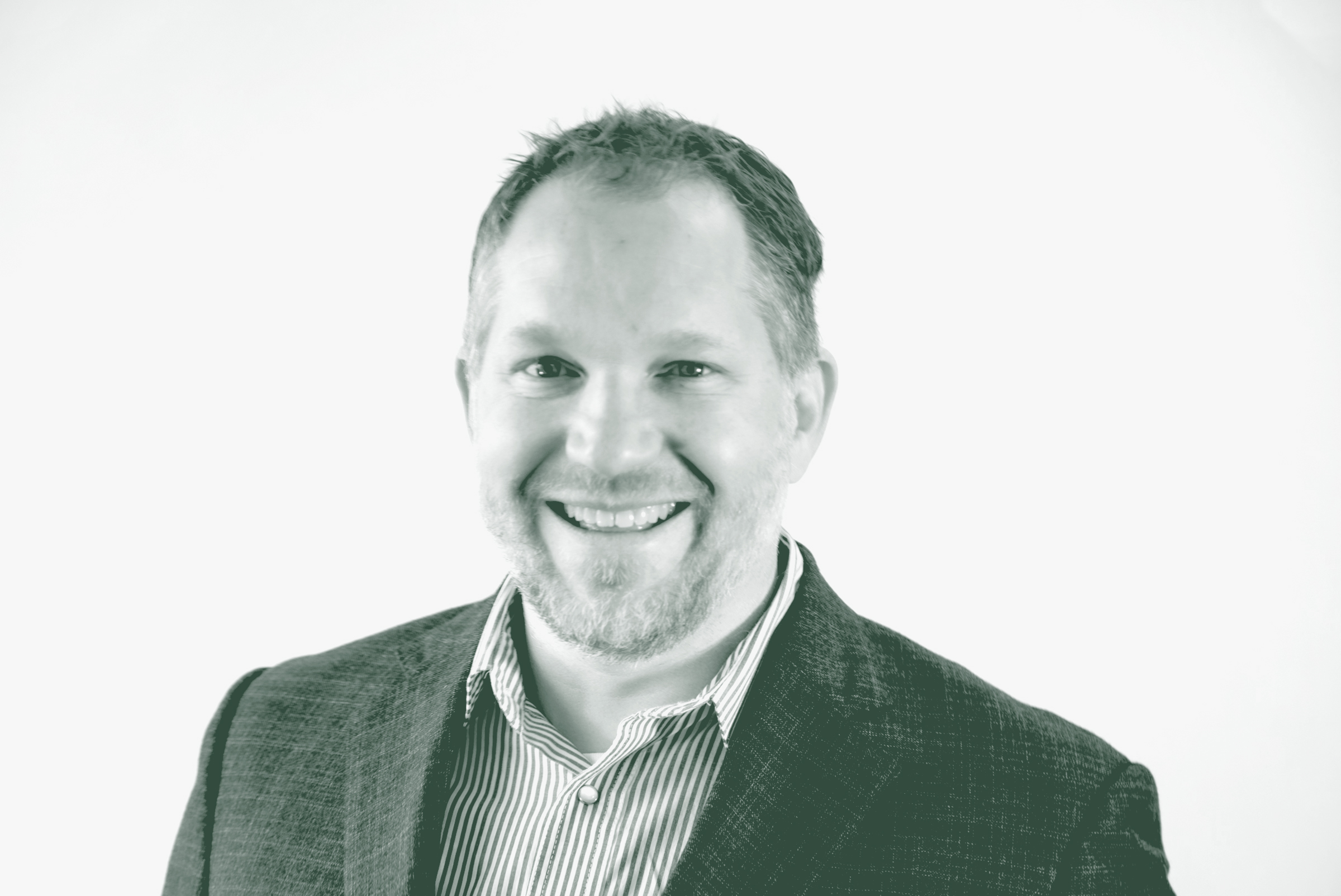 A black and white portrait of Andrew Adkison, an Associate Principal and the Director of AI with GFF, in front of a white background.