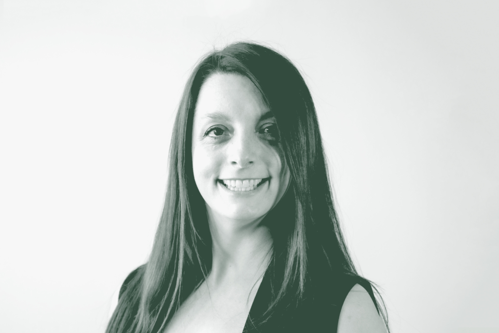 A black and white portrait of Beth Schmidt, an Associate and Senior Design Leader with GFF, in front of a white background.