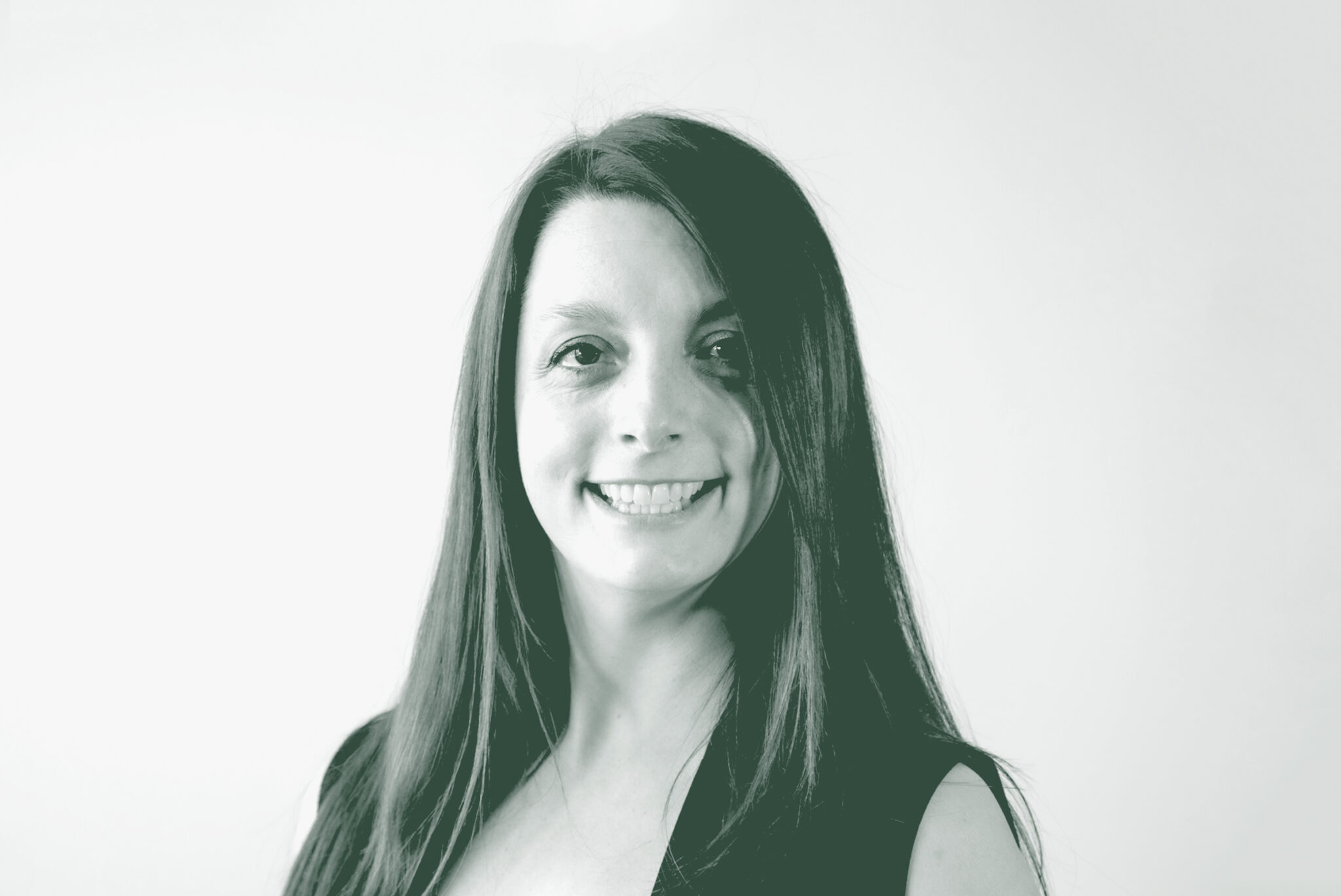 A black and white portrait of Beth Schmidt, an Associate and Senior Design Leader with GFF, in front of a white background.