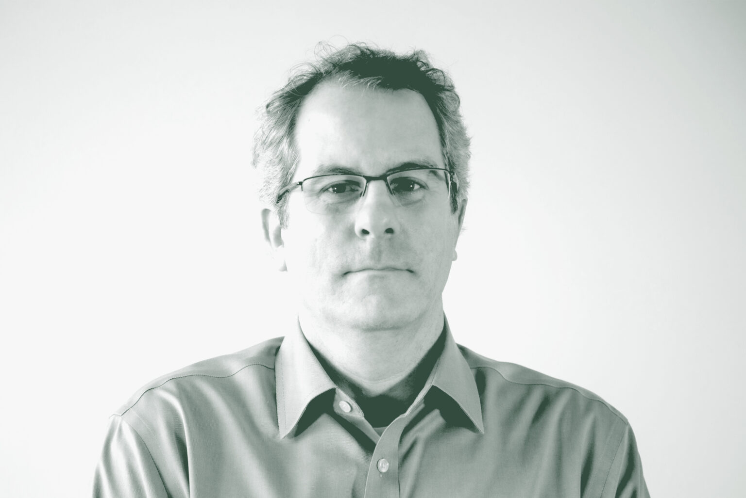 A black and white portrait of David Boone, an Associate Principal and Senior Project Leader with GFF in the Interior Design Studio, in front of a white background.
