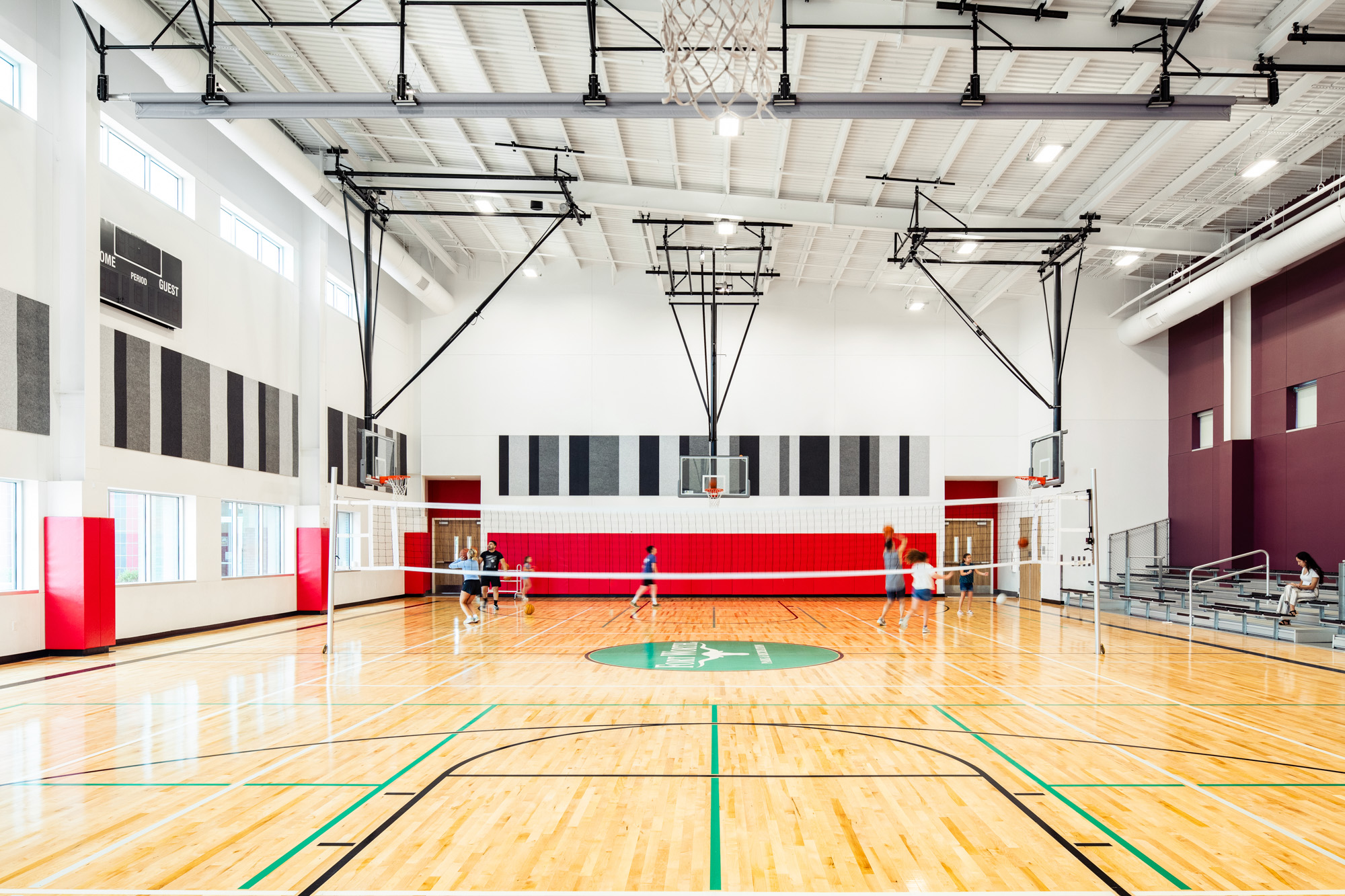 A competition-sized gymnasium with basketball and volleyball setups inside the Diamond Hill Community Center.