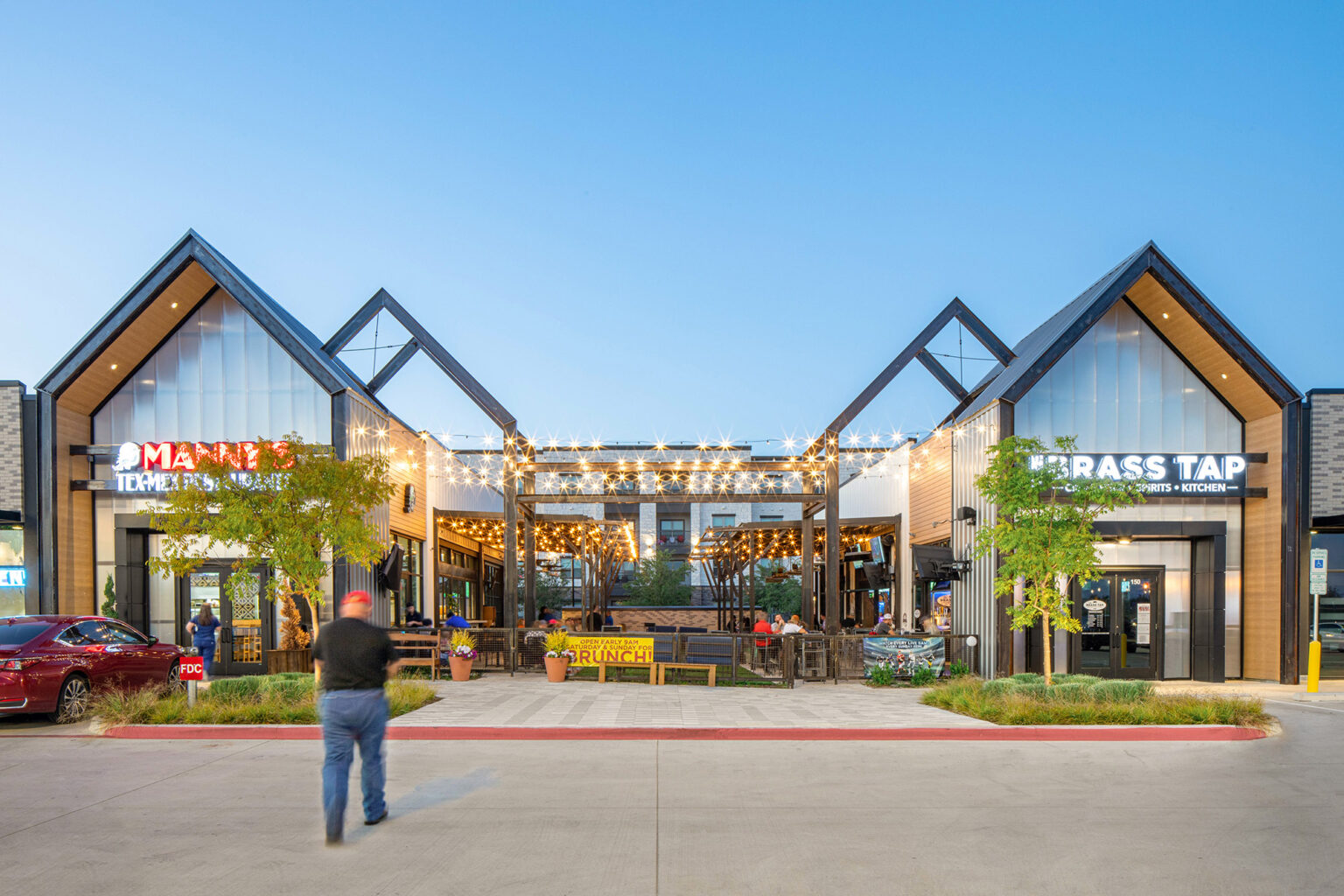 Retail entrance with shared green space at The Station - Sachse, Texas