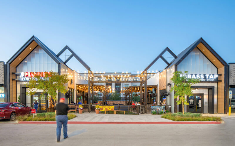 Retail entrance with shared green space at The Station - Sachse, Texas