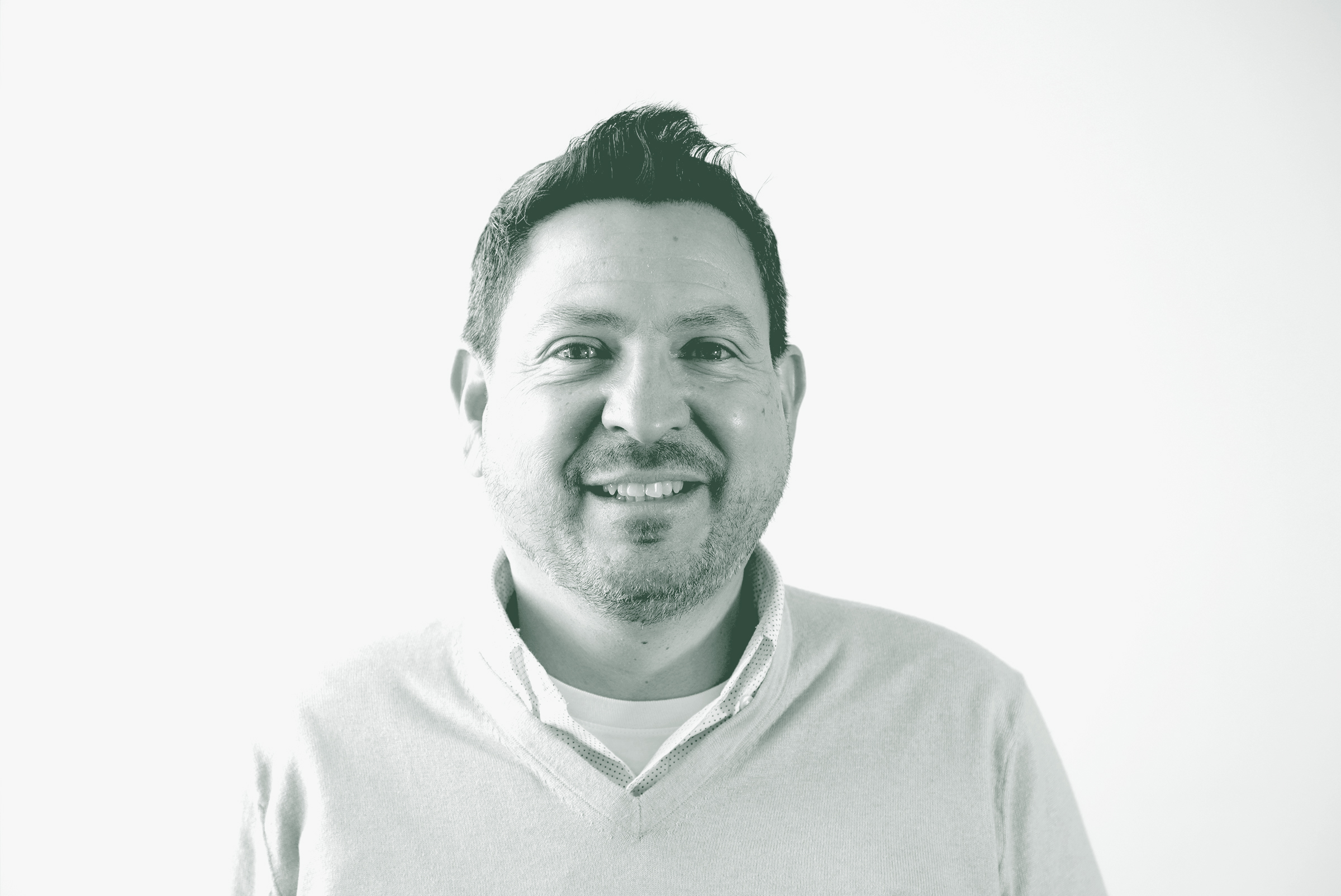 A black and white portrait of Eric Marquez de la Plata, a Senior Project Leader with GFF in the Retail & Hospitality Studio, in front of a white background.