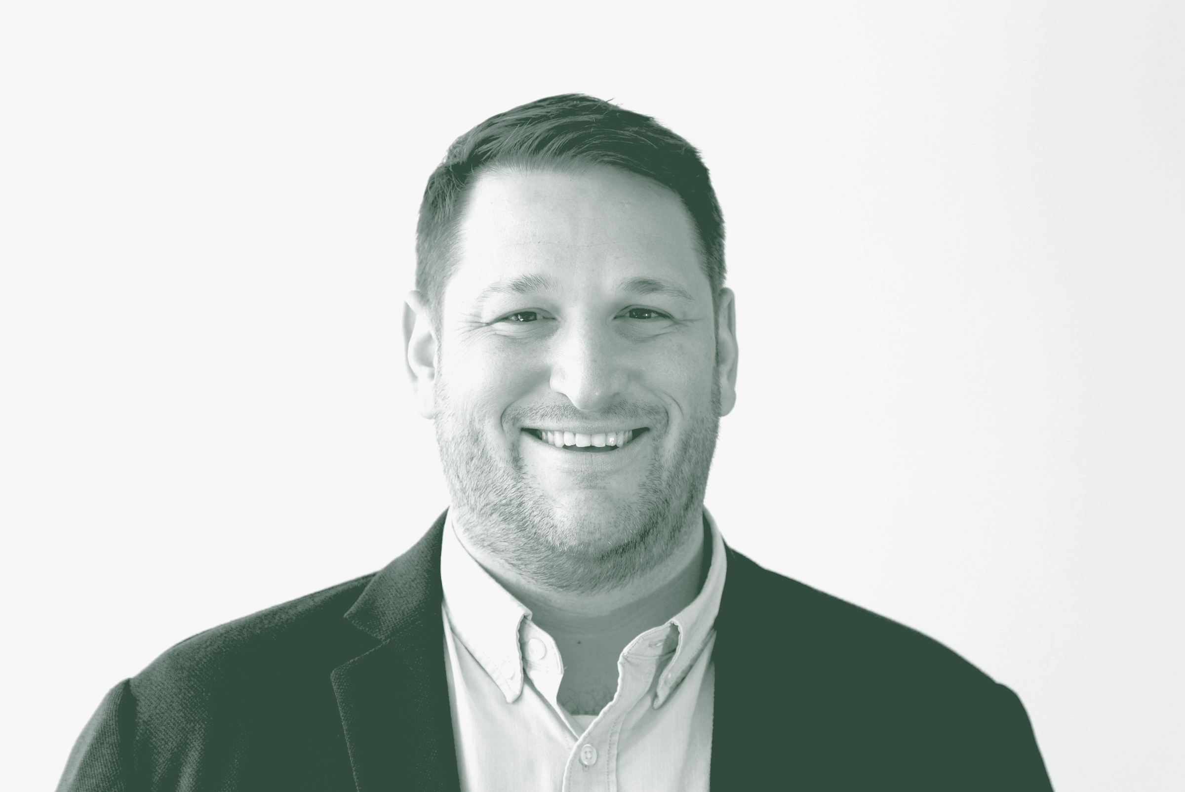 A black and white portrait of Jeremy Roehr, an Associate Principal and Studio Director with GFF in the EK-12 & Higher Ed Studio, in front of a white background.